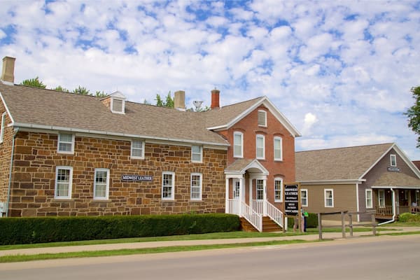 A stone building with a sign reading "Midwest Leather" and another sign for "Village Store."