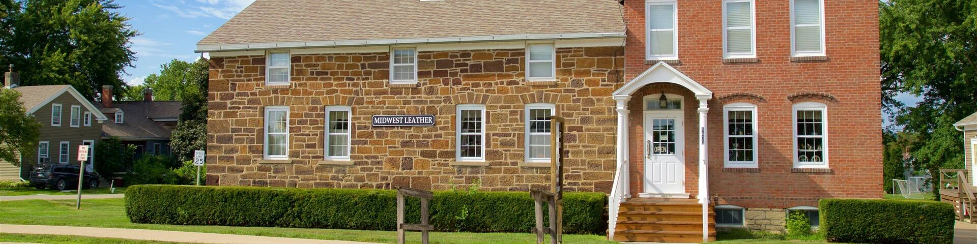 A stone building with a sign reading "Midwest Leather" on the front.
