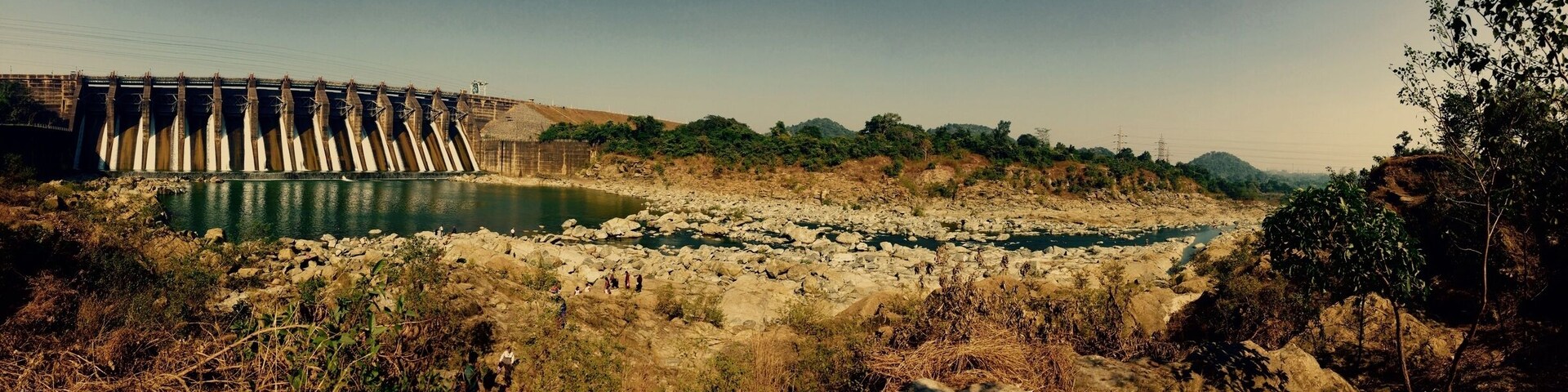 A dam with water flowing through a rocky riverbed.