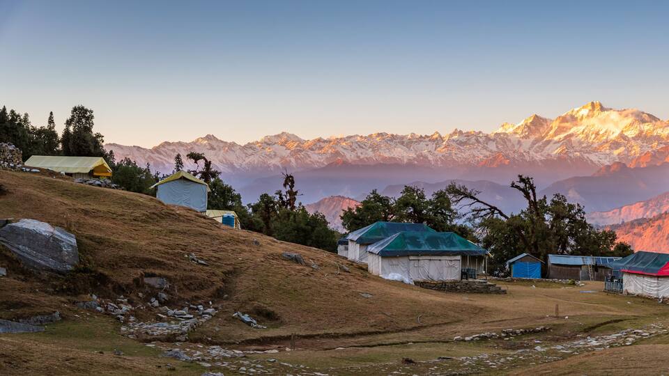 A mountainous landscape with tents and a clear sky.