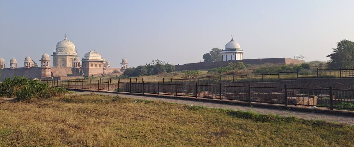 A historical fort with multiple domed structures and a surrounding fence.