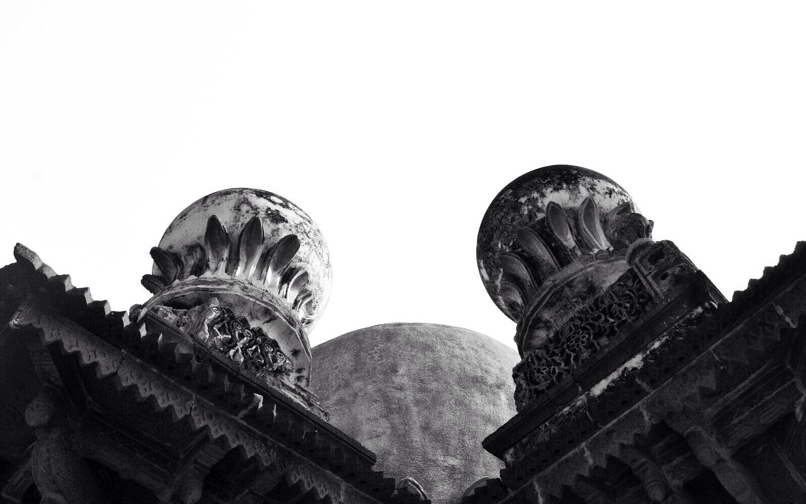 A historical building with ornate domes and intricate carvings.