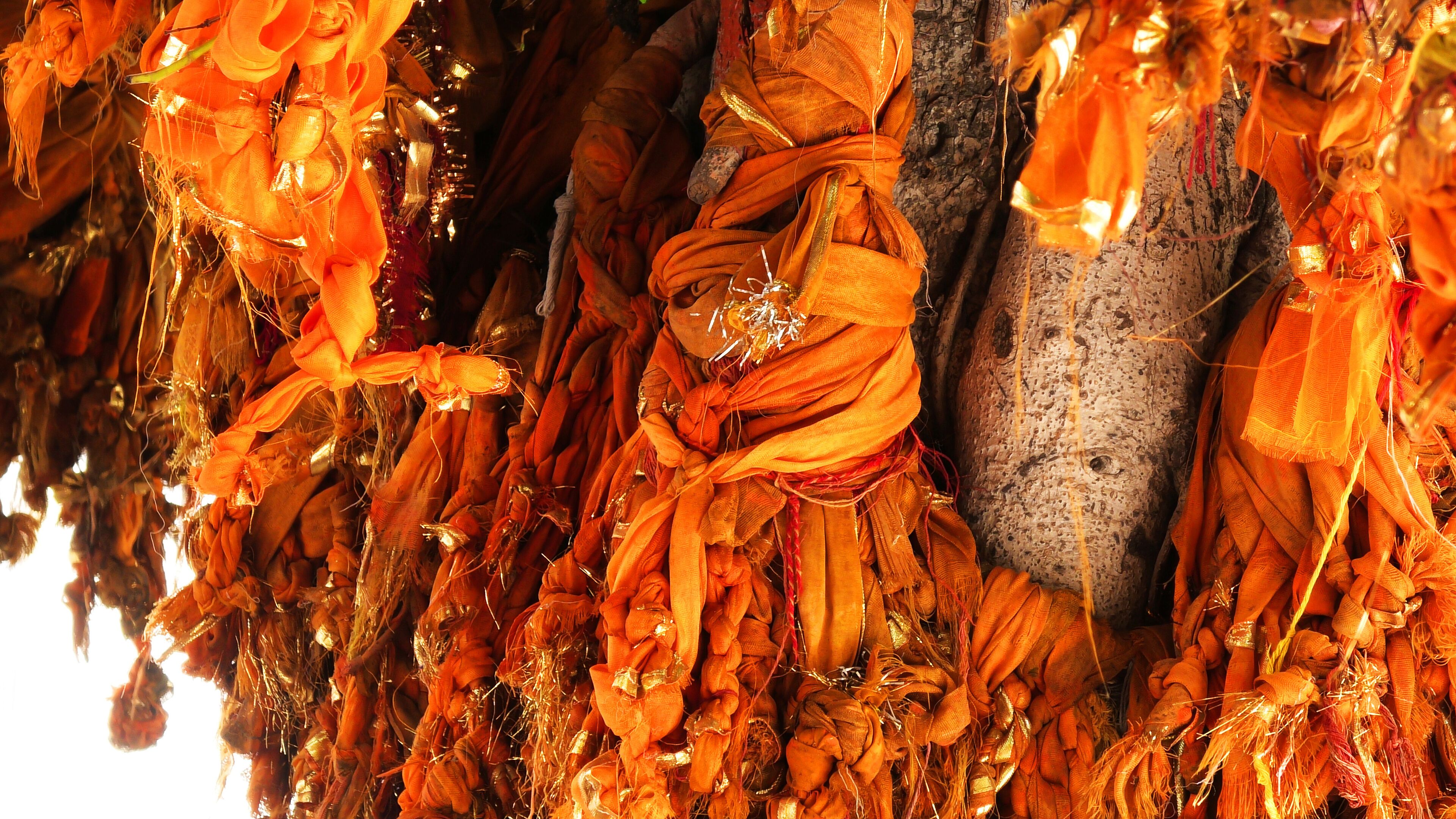 A close-up of orange fabric decorations, possibly for a cultural event or festival.