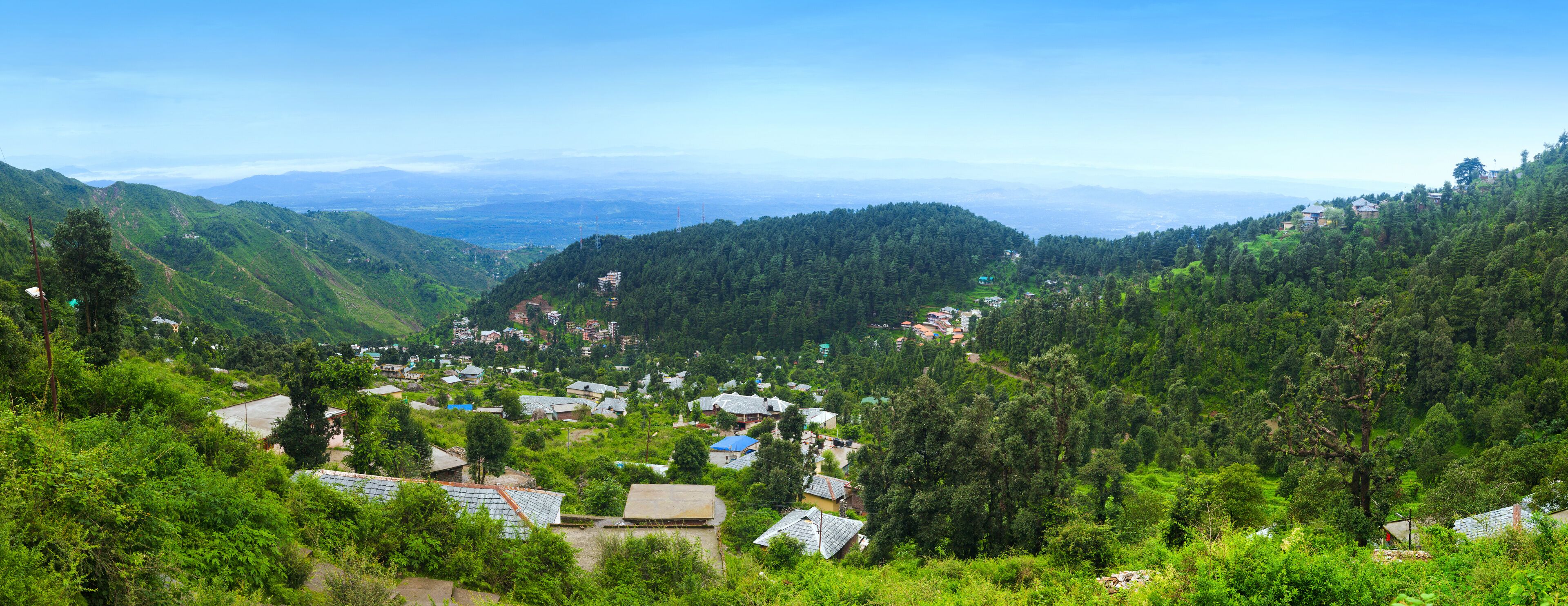 A mountainous village with terraced fields and traditional houses.