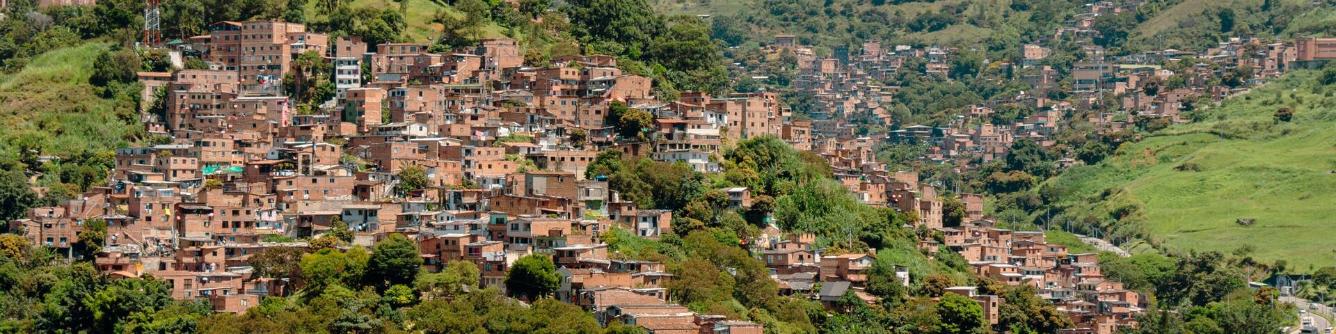 A densely packed hillside town with numerous brick buildings.