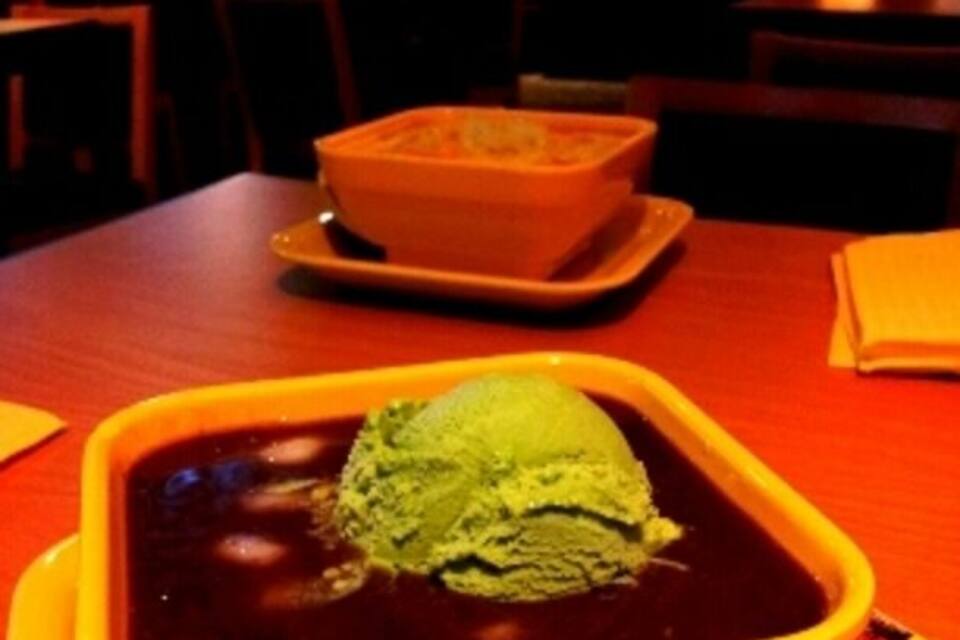A bowl of matcha ice cream on a plate.
