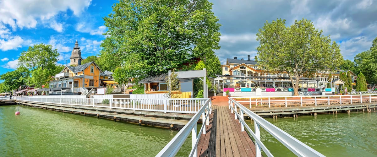 Panoramic cityscape with embankment and marina in Naantali town at sunny summer day. Finland