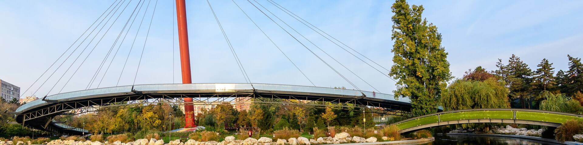 Landscape with the lake and suspended bridge from Drumul Taberei Park, also known as Moghioros Park, in Bucharest, Romania, at sunrise in an autumn morning.