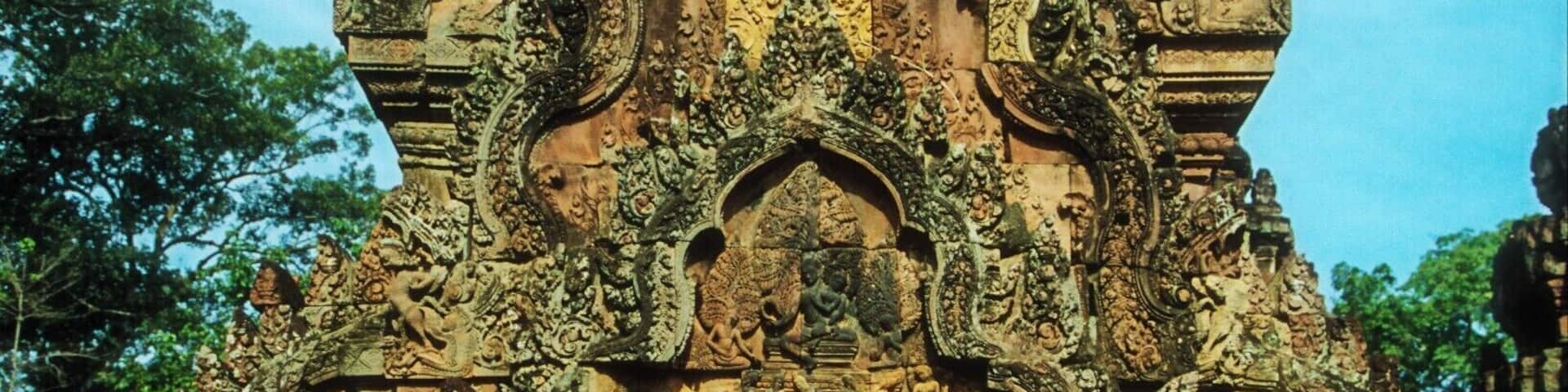 A detailed stone structure with intricate carvings and a central door.