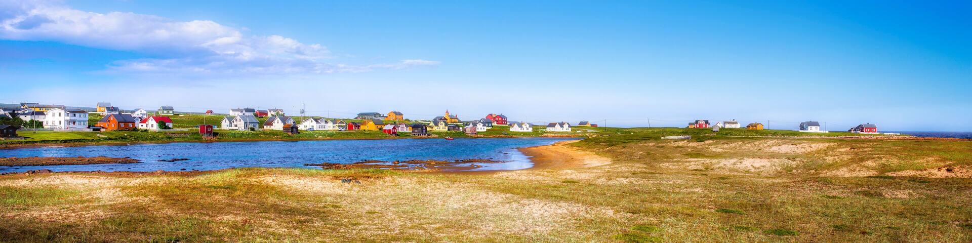 A coastal village with colorful houses by the water.