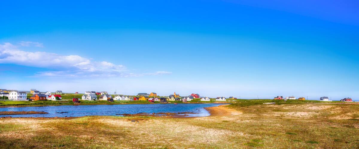A coastal village with colorful houses by the water.