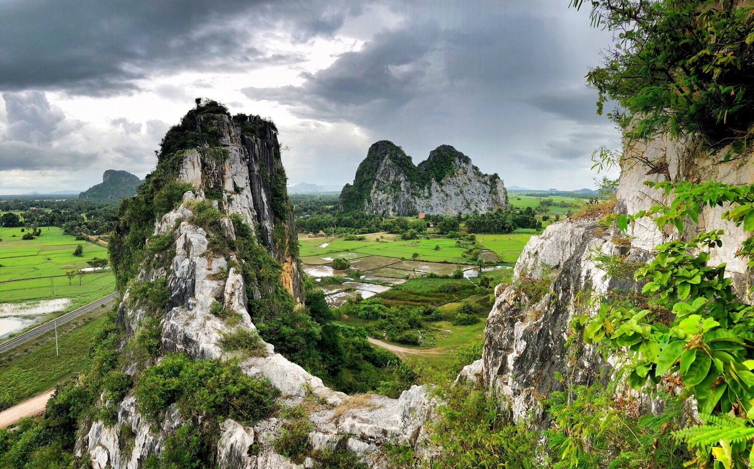 A mountainous landscape with rugged cliffs and lush greenery.