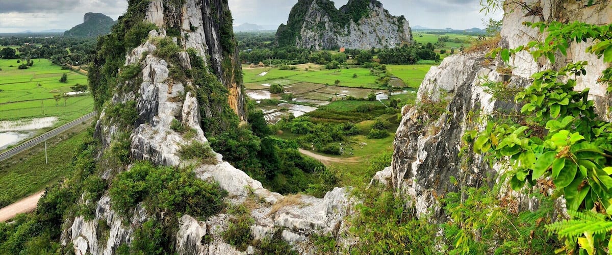 A mountainous landscape with rugged cliffs and lush greenery.