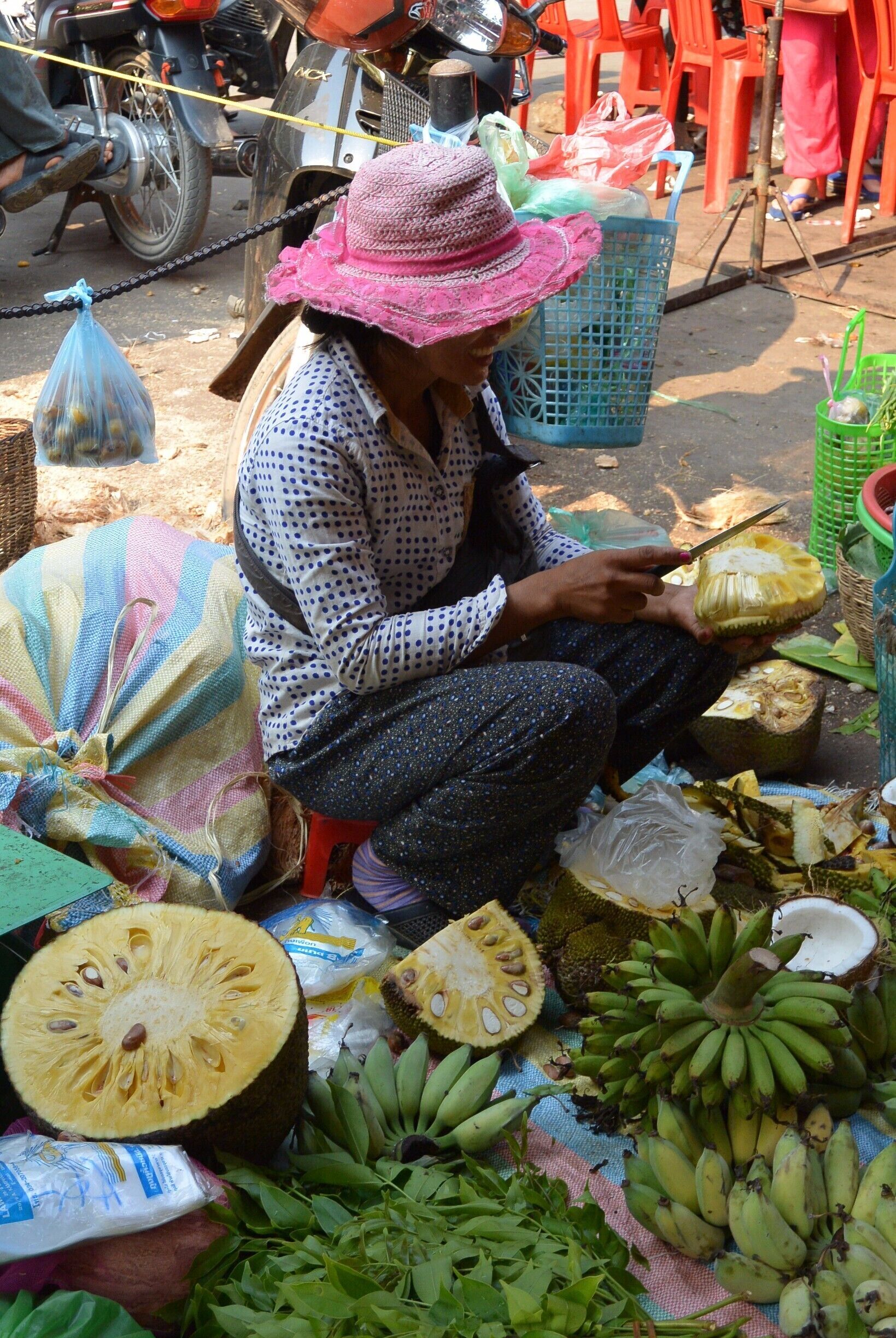 A vendor selling fruits and vegetables at a market.