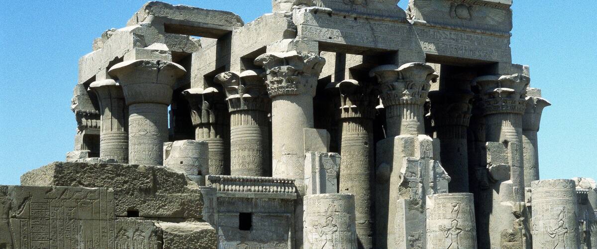 Ancient Egyptian temple columns with hieroglyphics.