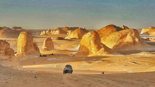 Sunset light simply paints the calcite/lime rocks golden hue from white.
The huge rocks look out of the world