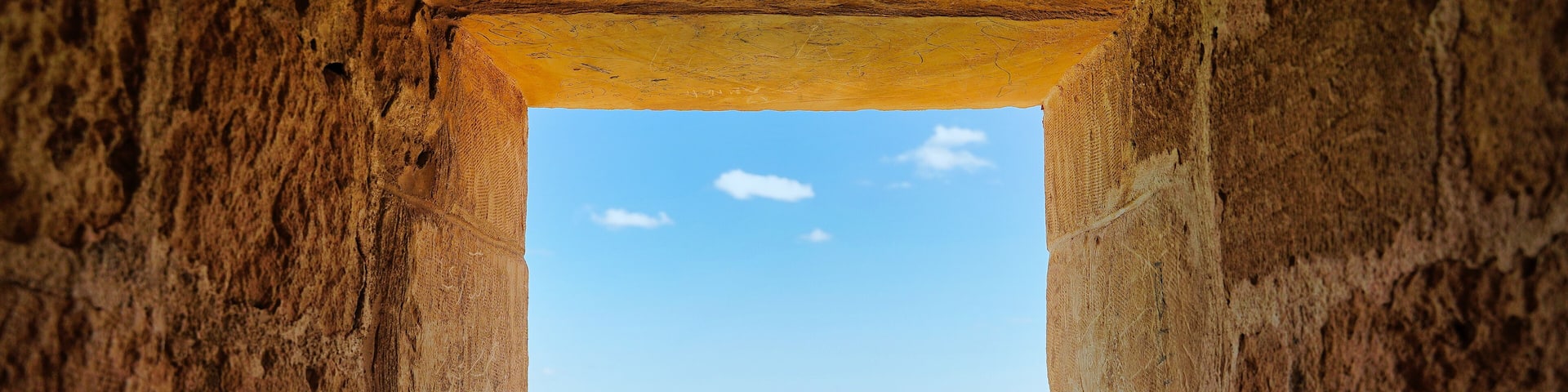 A window with a view over the massive stone walls into the blue Mediterranean sea at the Citadel of Qaitbay,built by the Mamluk Sultan Qaitbay in 1479 AD,Pharos Island,Alexandria,Egypt