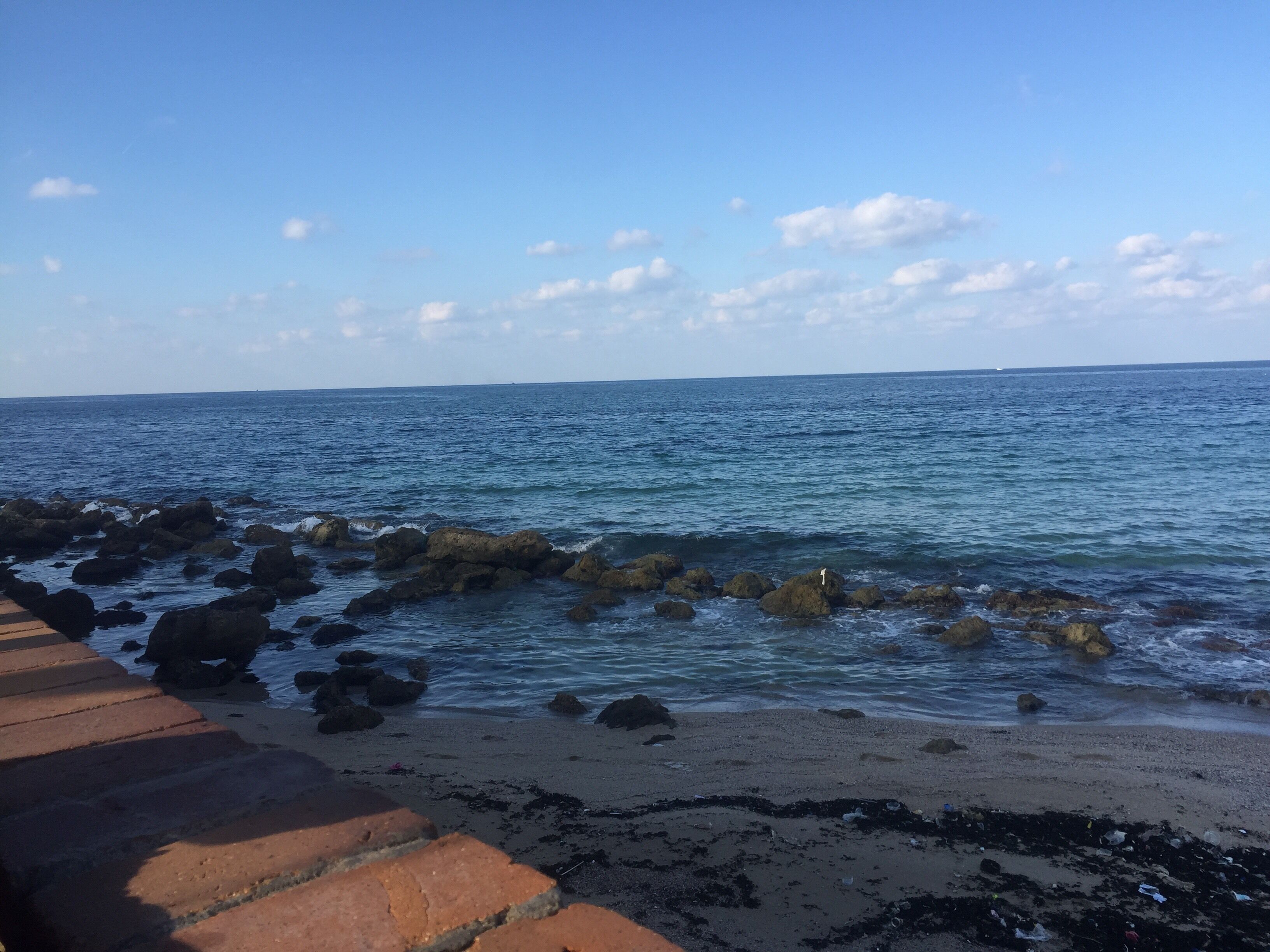 A rocky shoreline with waves crashing against the rocks.