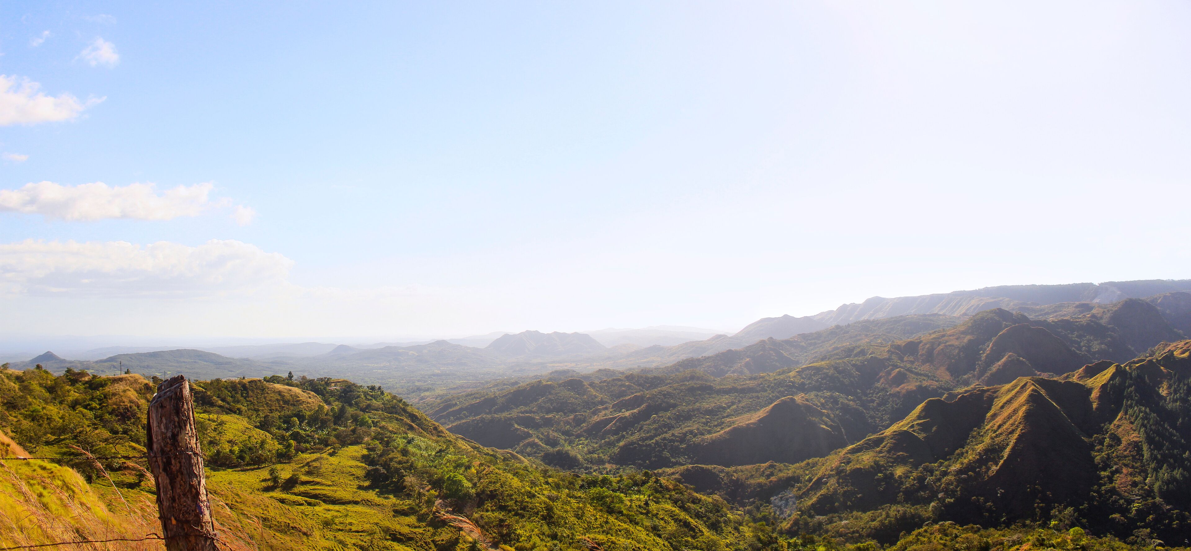 A mountainous landscape with rolling hills and a clear sky.