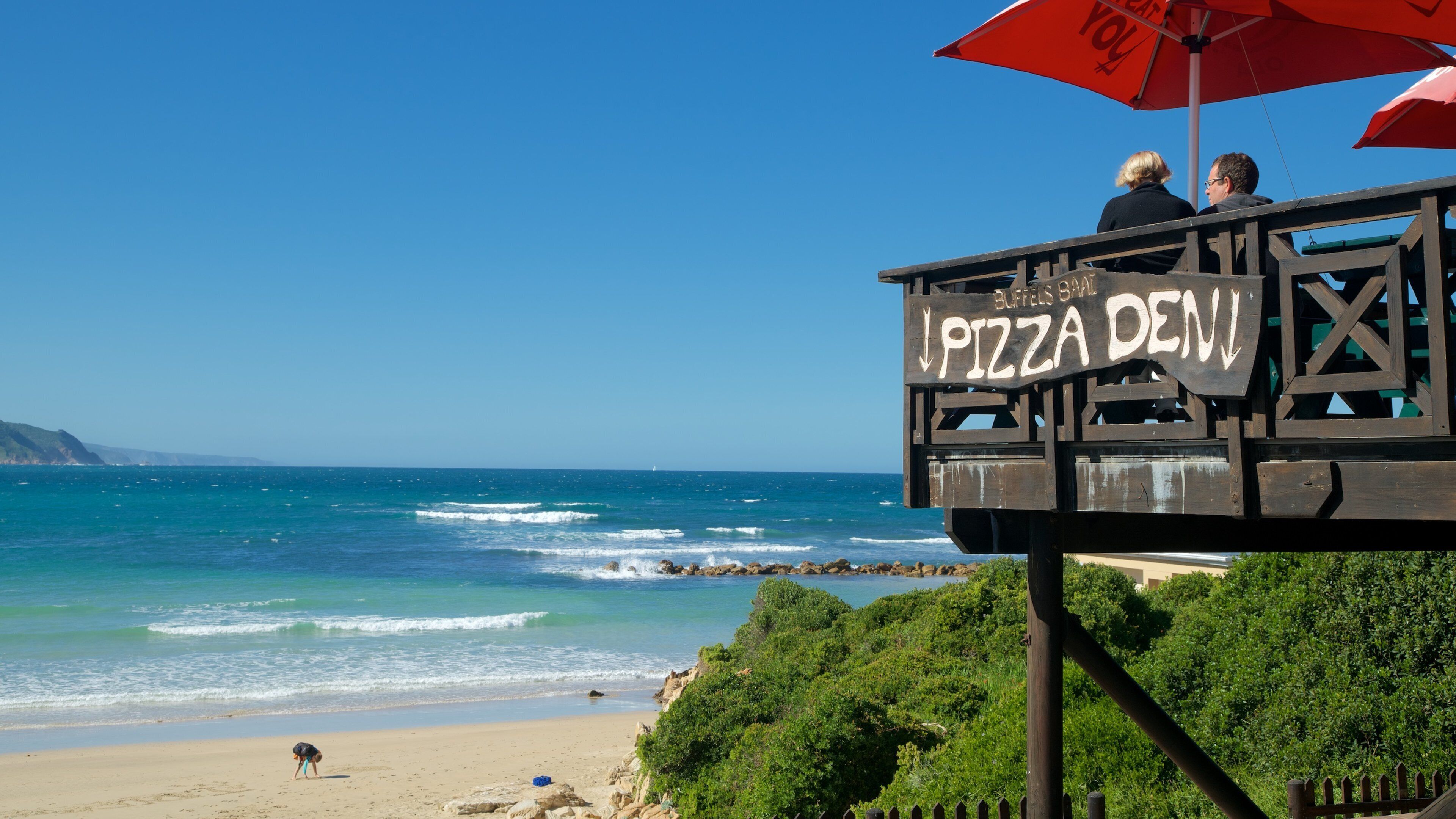 Knysna que inclui paisagens, uma praia de areia e sinalização