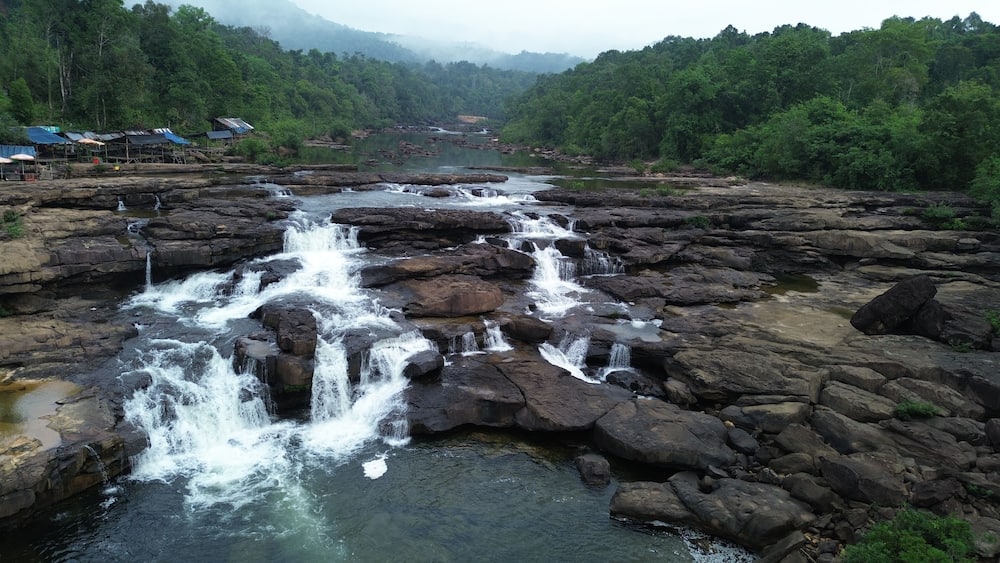 Aerial view of majestic Tatai Waterfall in Koh Kong Province surrounded by dense jungle, Cambodia