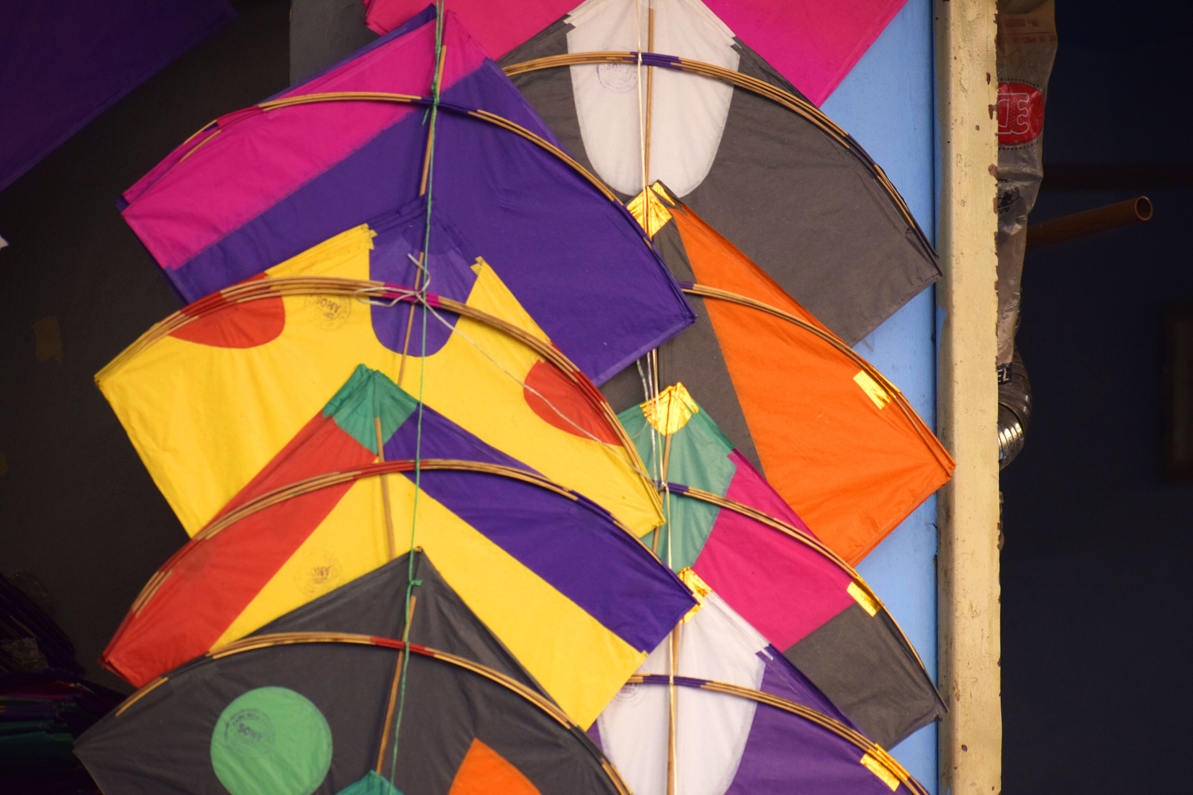 A collection of colorful kites tied together.
