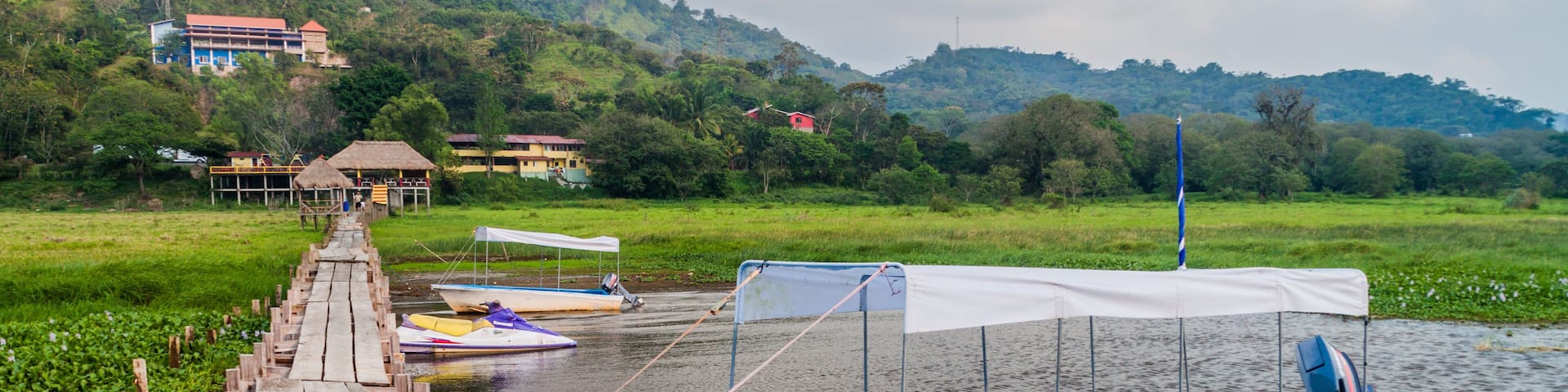Wooden piers and boats at lake Yojoa, Honduras