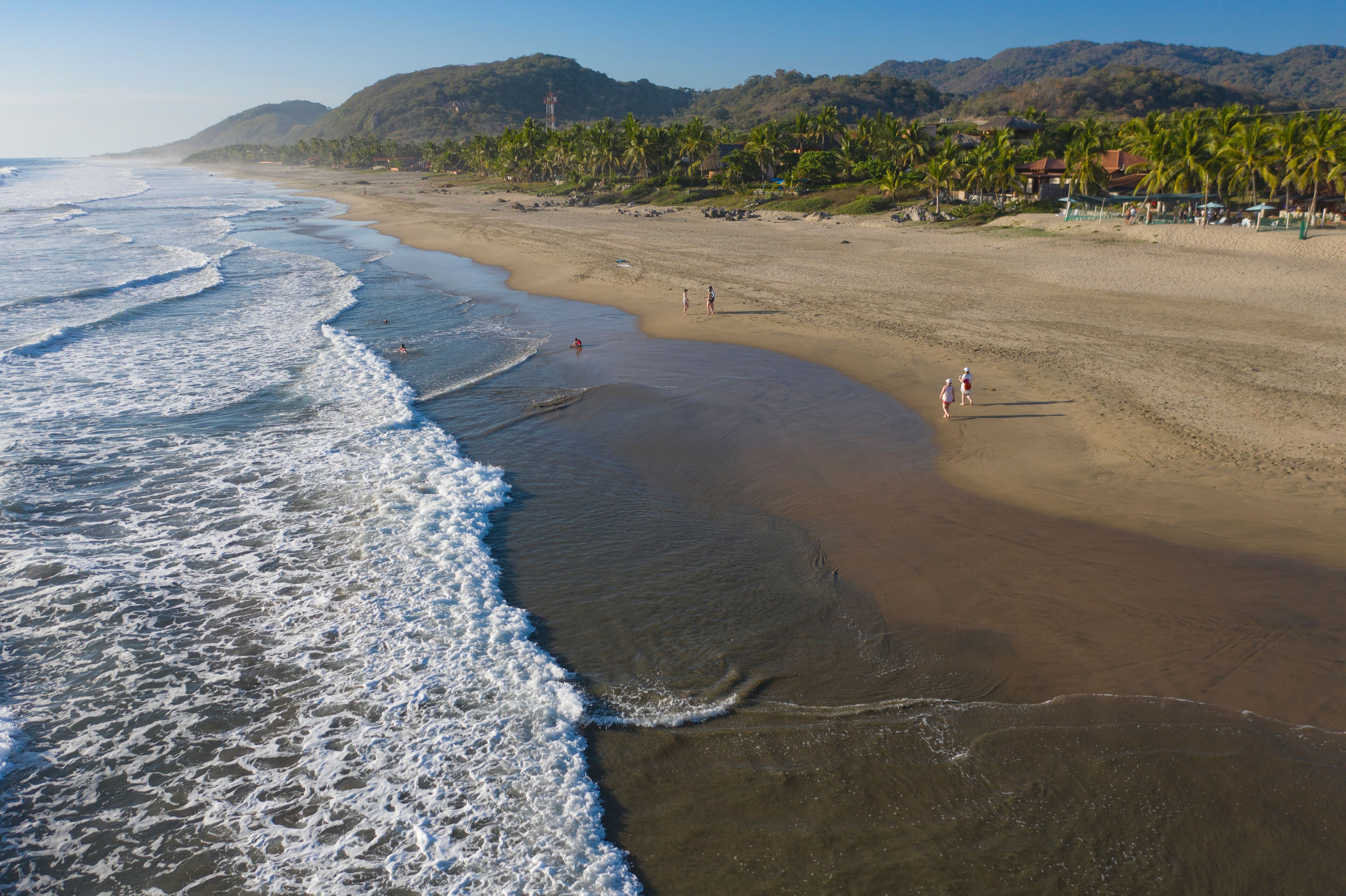 Aerial view of beautiful Playa Troncones with tranquil waves and sandy shoreline, Troncones, Mexico.