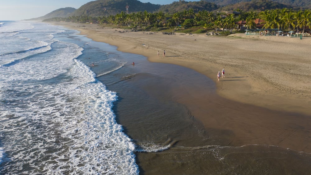 Aerial view of beautiful Playa Troncones with tranquil waves and sandy shoreline, Troncones, Mexico.
