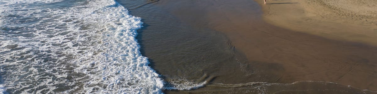 Aerial view of beautiful Playa Troncones with tranquil waves and sandy shoreline, Troncones, Mexico.
