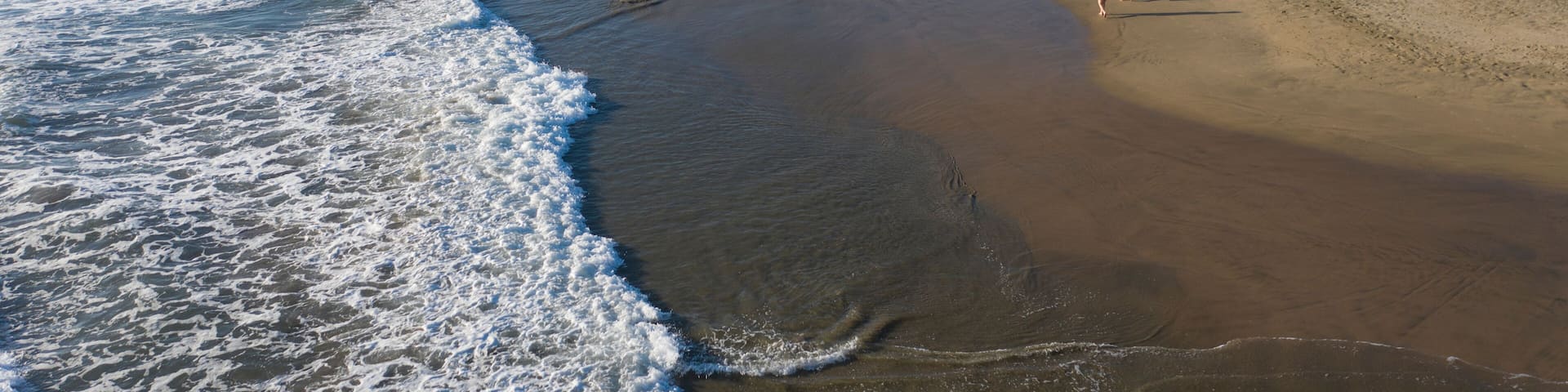 Aerial view of beautiful Playa Troncones with tranquil waves and sandy shoreline, Troncones, Mexico.