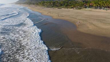 Aerial view of beautiful Playa Troncones with tranquil waves and sandy shoreline, Troncones, Mexico.