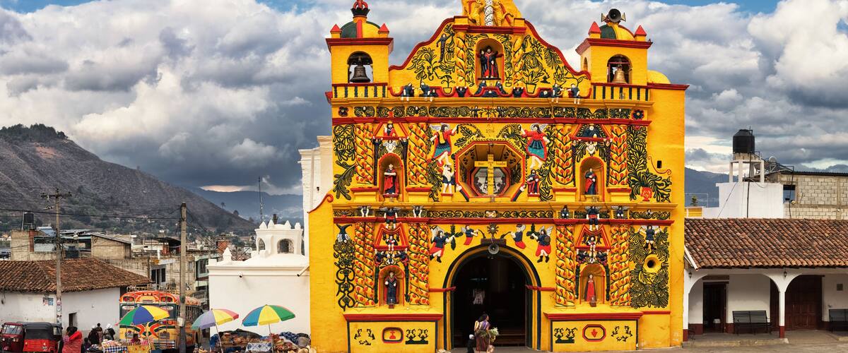 A colorful church with intricate murals and a bell tower.