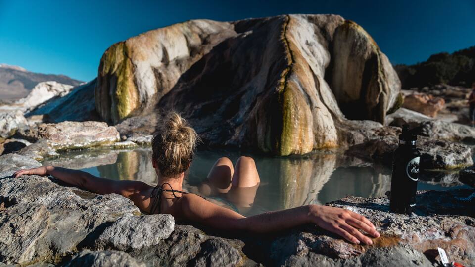 White female bathing in natural hot springs.