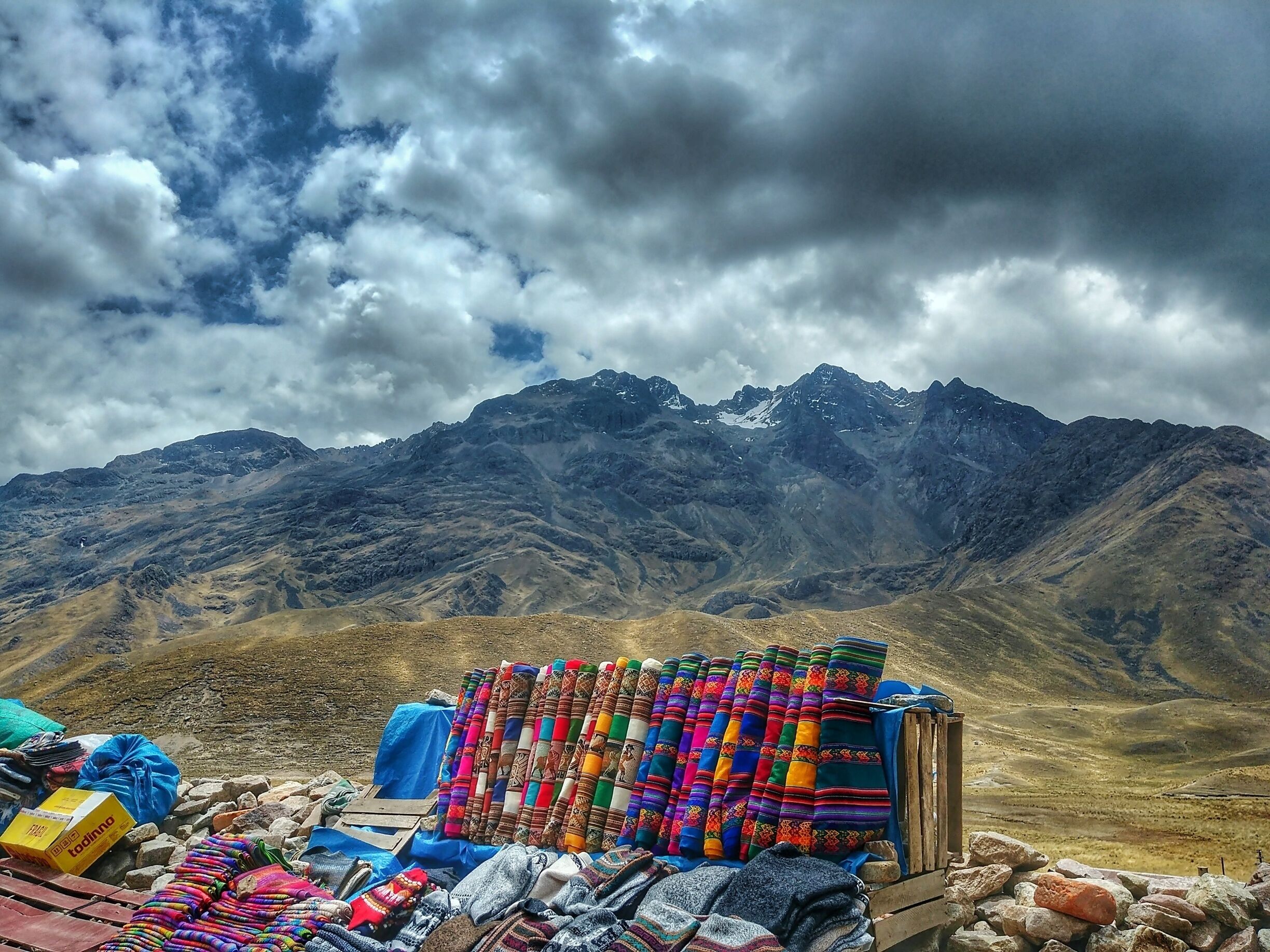 A mountain range with a colorful textile display in the foreground.
