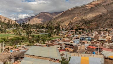 A town nestled in a valley with mountains in the background.