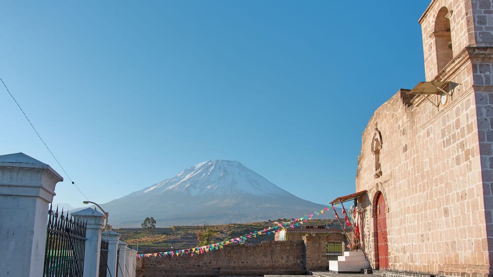 View of the church of Chiguata, in the background, the Misti volcano can be appreciated from afar, covered with snow on the summit."
