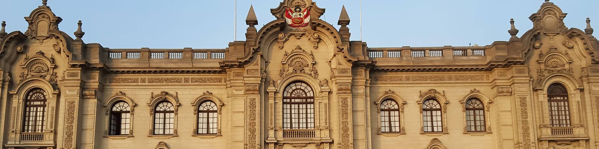 Government Palace located in the Plaza de Armas in the center of Lima, on an sunny afternoon being guarded by officers. Scenic urban landscape.