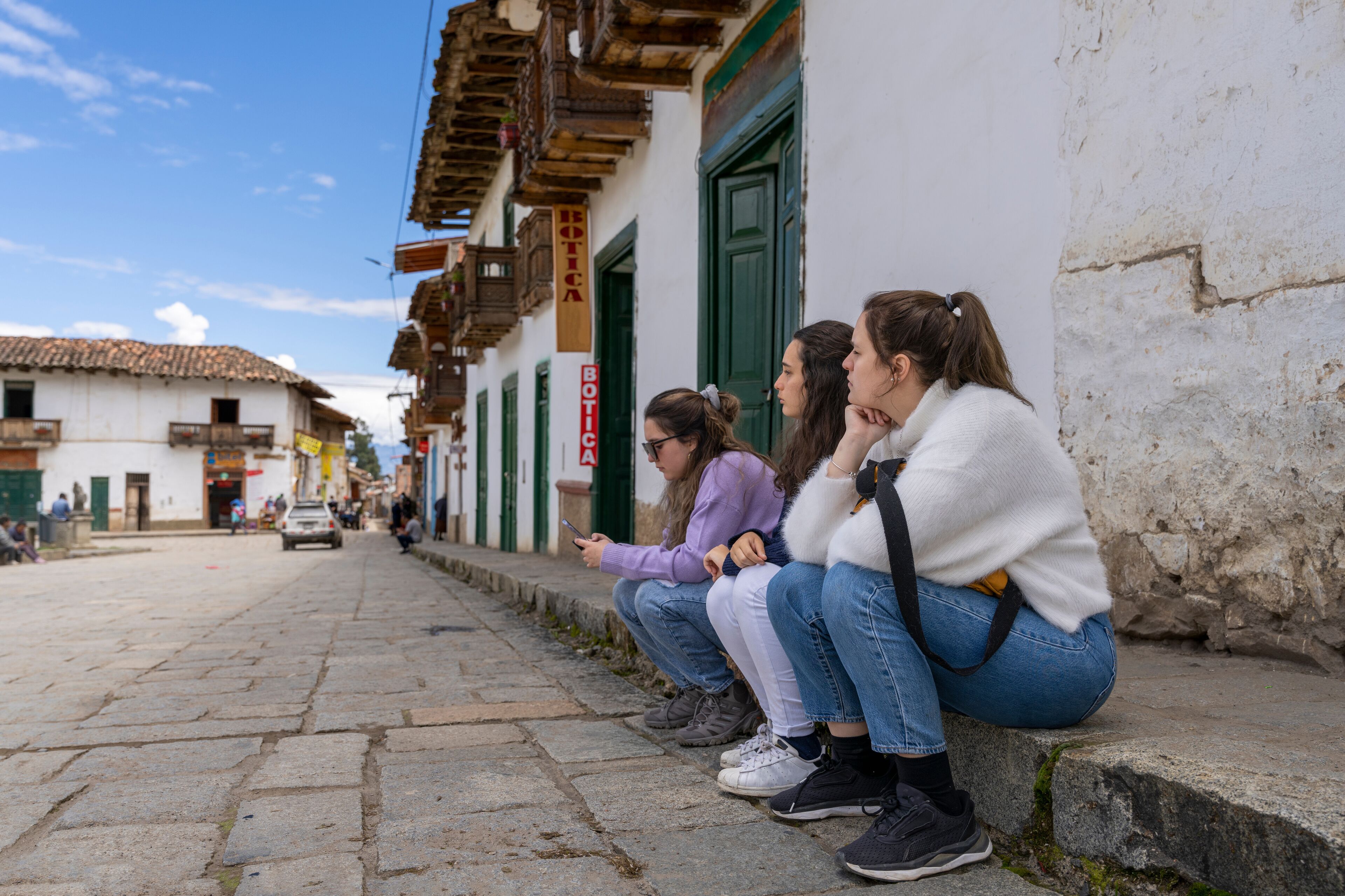 Three friends sitting on a ancient street