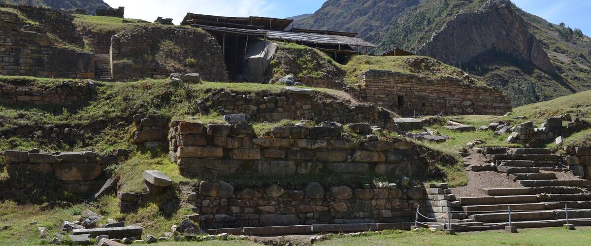 Ancient stone ruins with a mountain backdrop.