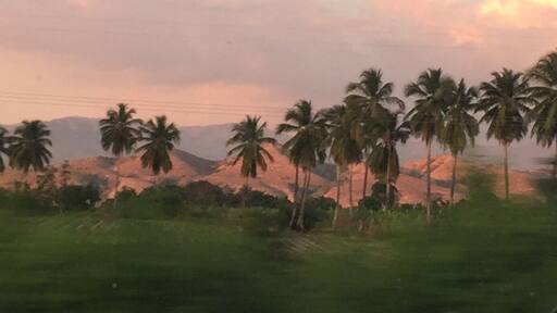 Puesta de sol entre lomas y cocoteros