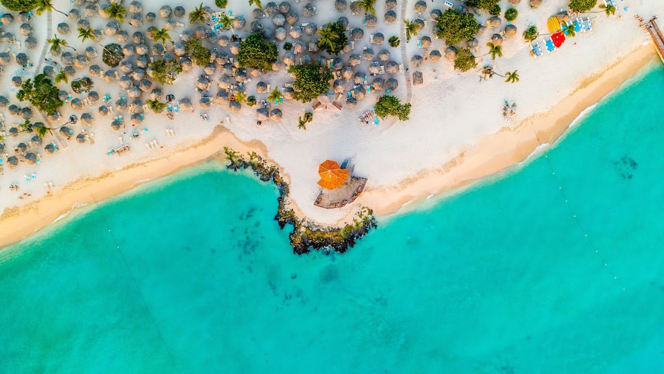 Aerial view of tourists enjoying the warm and crystal clear waters of the Caribbean at Bayahibe beach in San Rafael del Yuma, La Altagracia Province, Dominican Republic