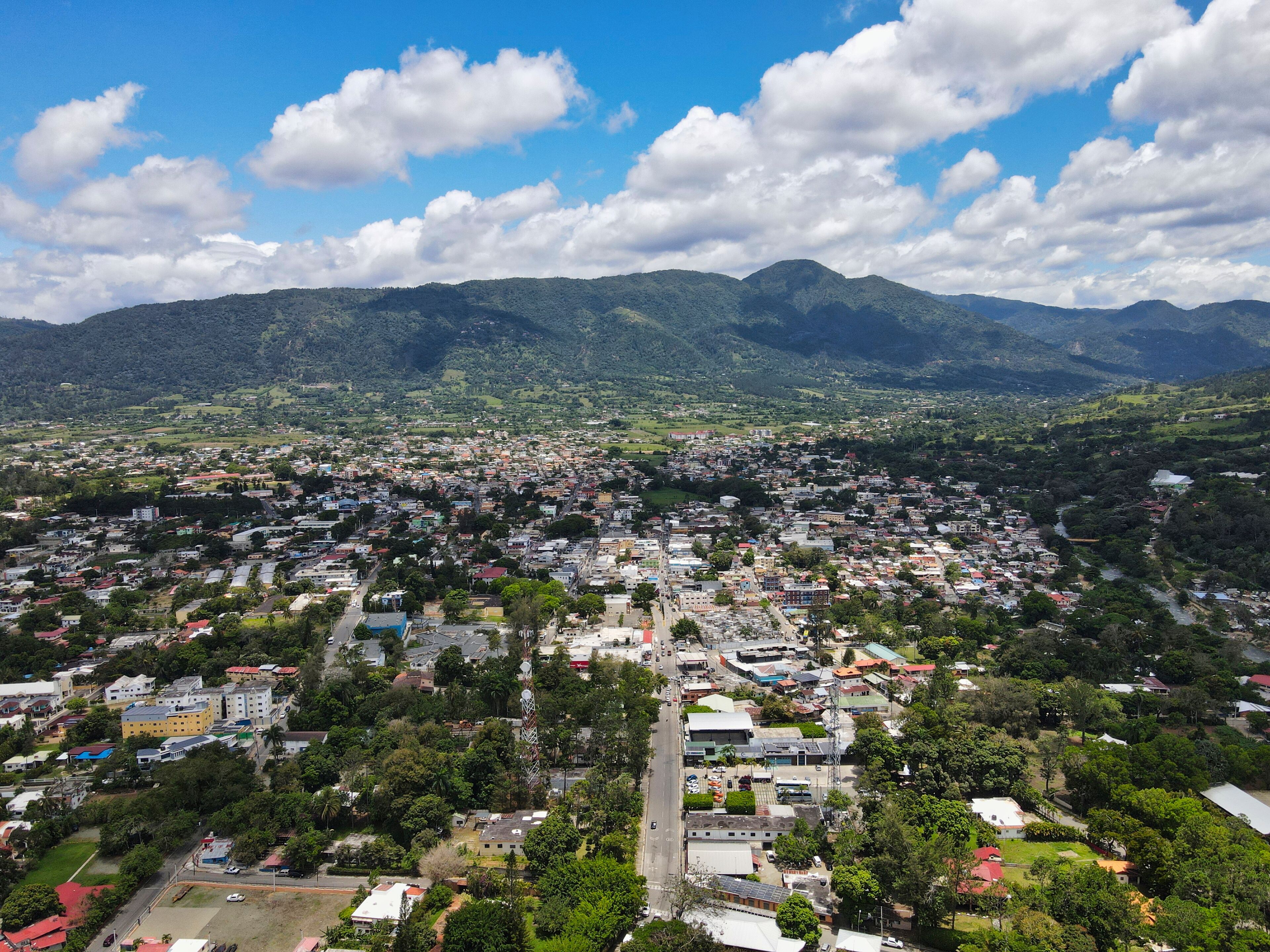 A cityscape with a mountain range in the background.
