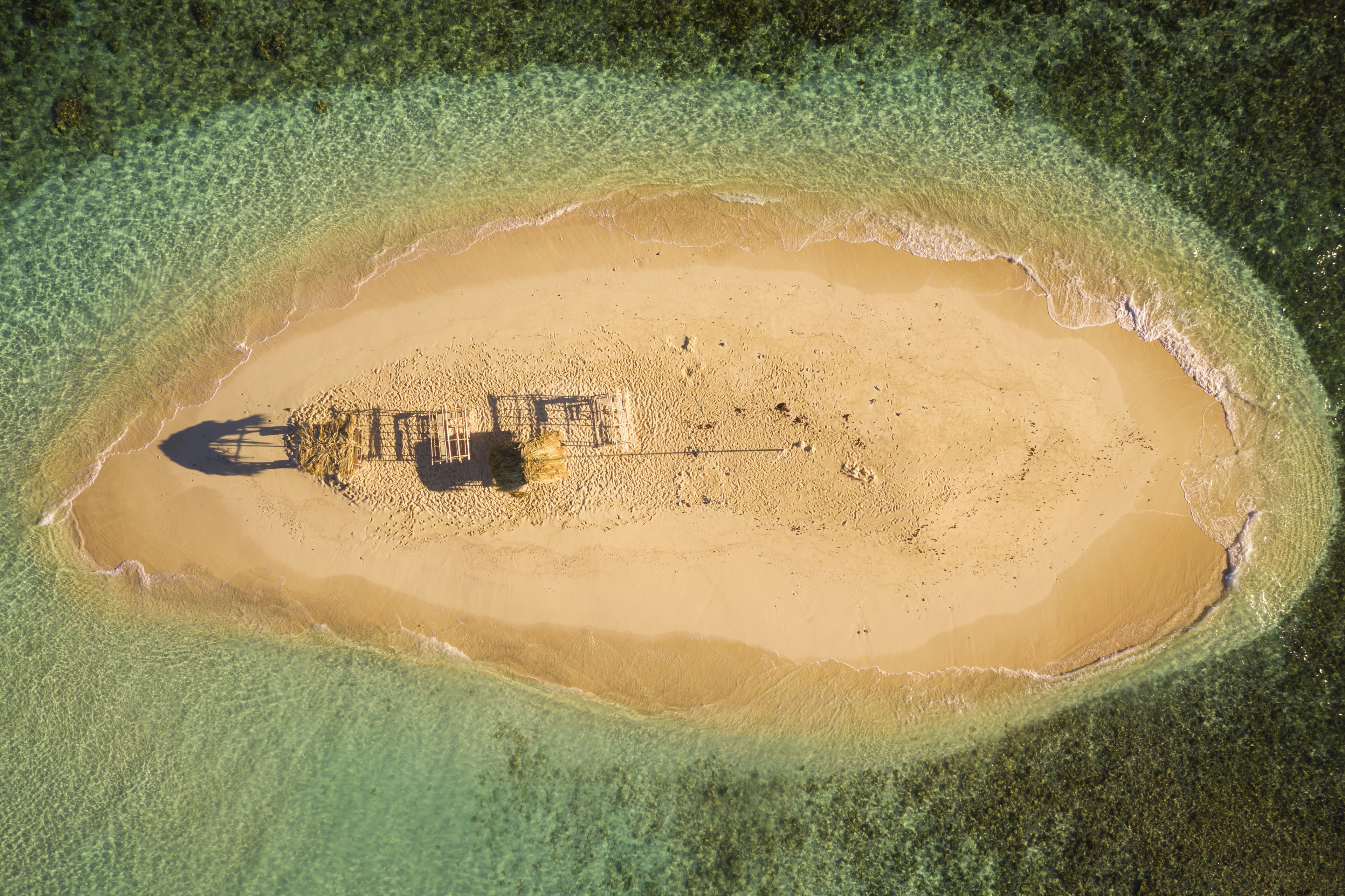 Aerial view of a small isolated wooden hut on the little island of Cayo Arena in Guayubin state, Dominican Republic.