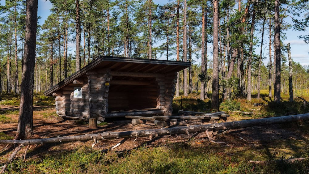 Leikkistenkangas traditional wooden Lean-To shelter and campfire site in Lauhanvuori National Park, Finland on a sunny day in autumn