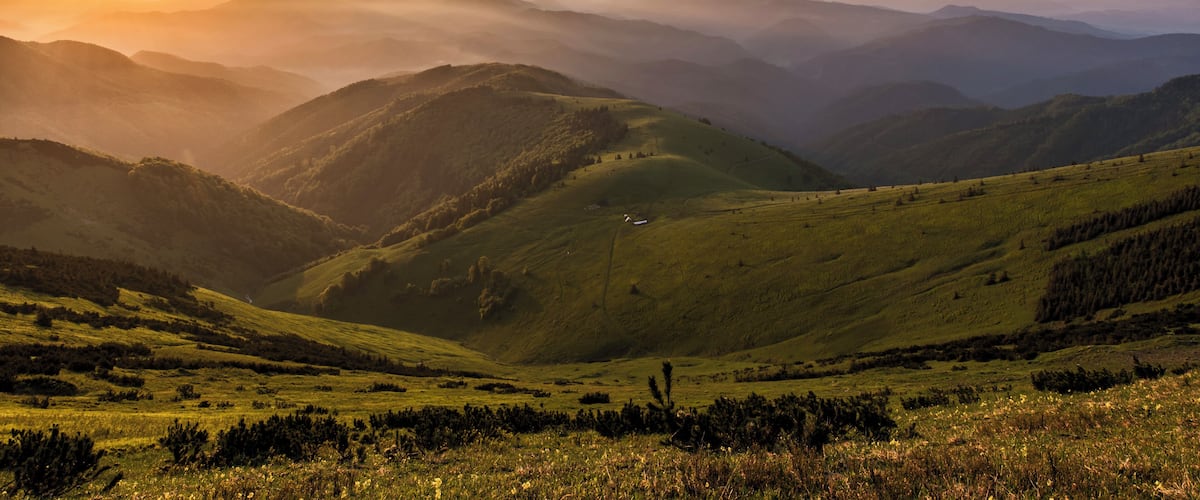 A mountainous landscape with rolling hills and a valley.
