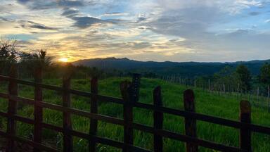 Sunset over fence. Sabana Grande de Boya, Dominican Republic