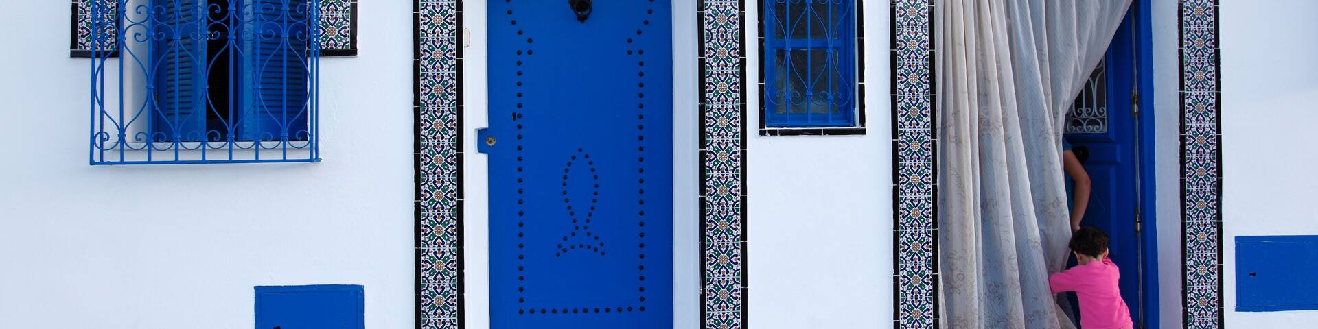 Young child and quayside house in the Old Port, Bizerte, Tunisia