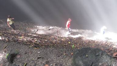 Going down into a sinkhole where it becomes nearly pitch black at the bottom. This sinkhole epitomizes light and darkness and beauty and is thought to have spiritual significance by the locals.