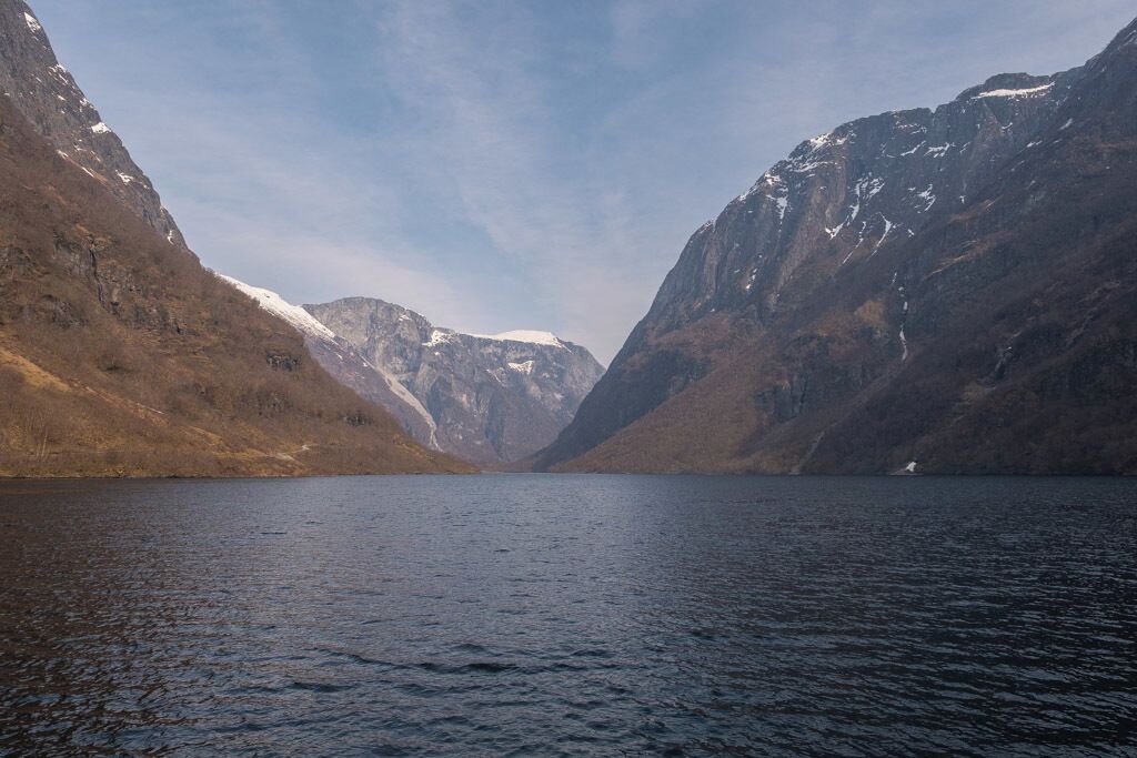 A lake surrounded by mountains with snow-capped peaks.